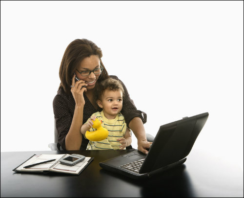 mom at laptop with child