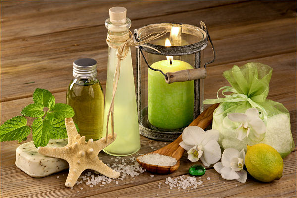 green candle and cosmetics