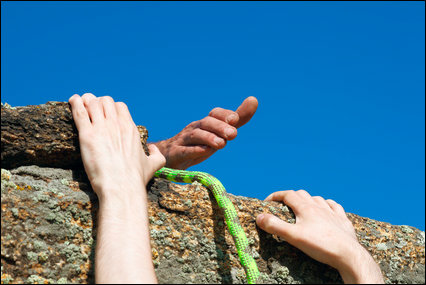 hands helping up a cliff